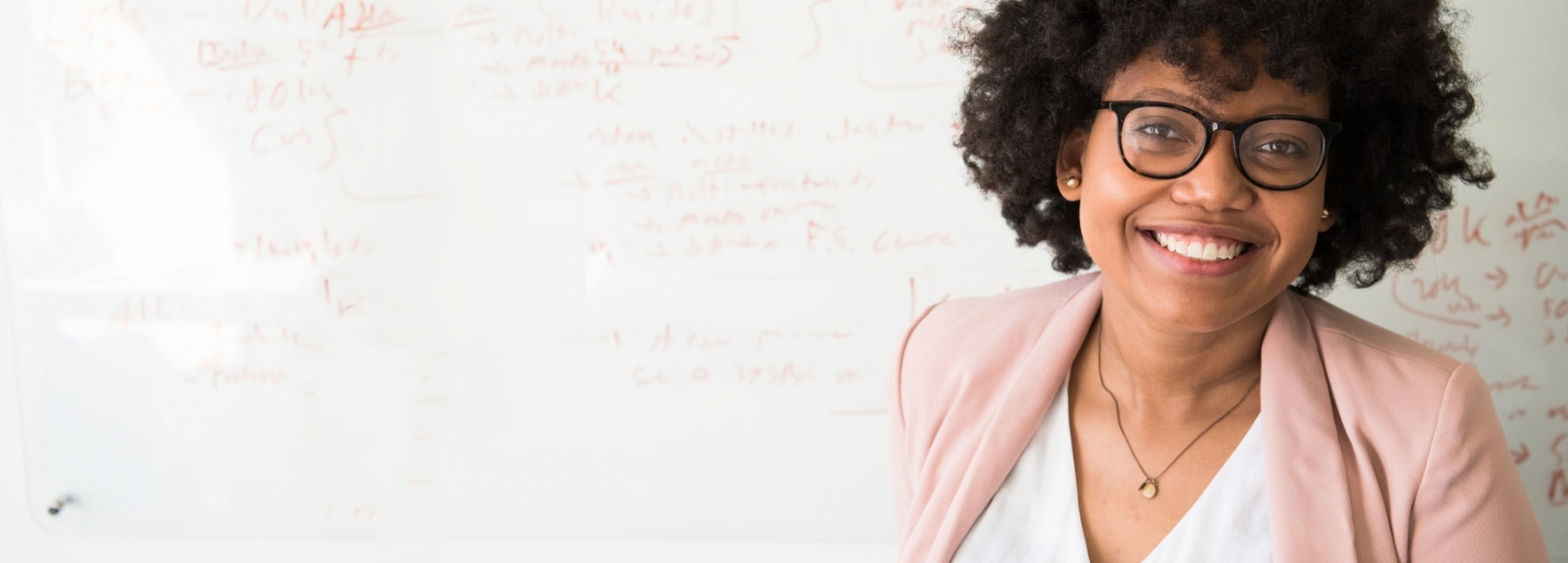 woman smiling at whiteboard