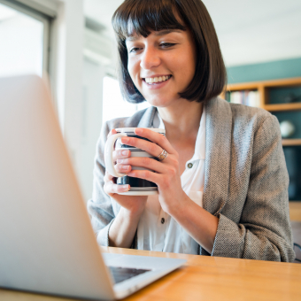 Women on virtual meeting with cup of coffee