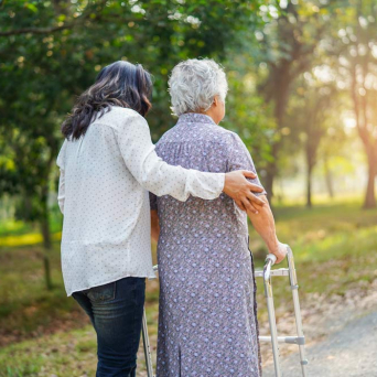 woman walking older woman with walker