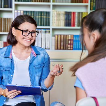 Woman counselor working with teenage girl
